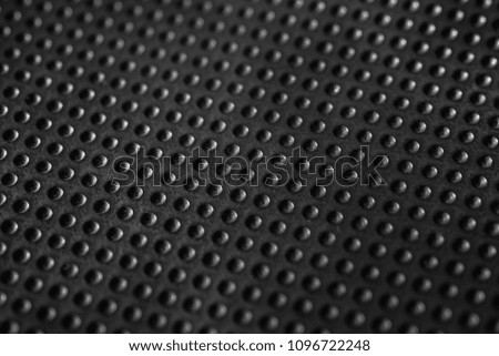 Black dotted texturised technological seamless fabric or surface closeup