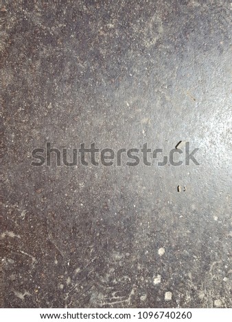 old metal floor with oil stains. over light and high contrast in background
