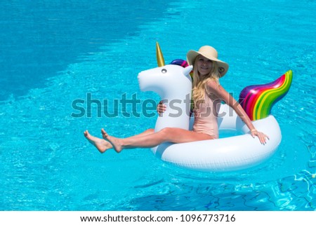Summer Vacation. Enjoying suntan Woman in bikini on the inflatable mattress in the swimming pool. With copy space