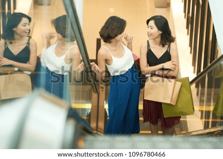 Happy young Asian women enjoying shopping in mall