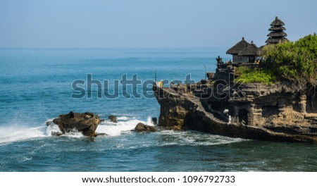 View of Tanah Lot temple on the sea at sunny day in Bali, Indonesia.