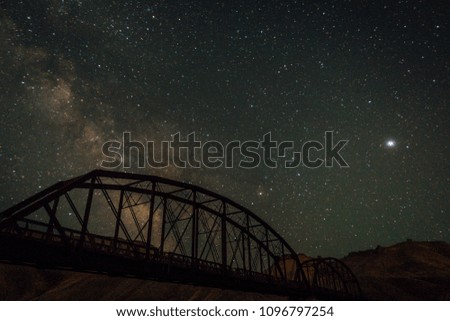 Milky way night sky with old railroad bridge foreground. 