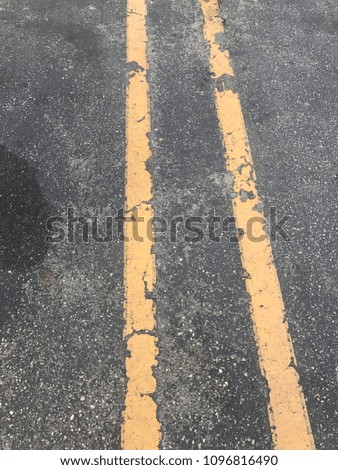 Parallel yellow parking lines on asphalt