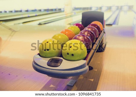 Balls for bowling game with blurry bowling lanes.