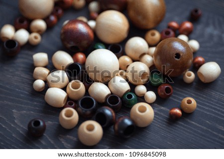 A group of colorful beads on a wooden background