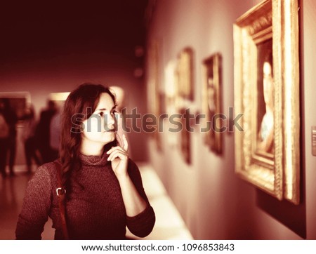 Closeup on attentive adult woman visiting museum and pleased arts