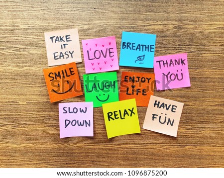 Colorful of notes with hand writing of positive attitude words on the wooden background