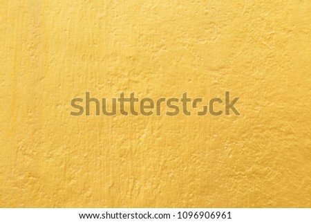 Gold paint on cement wall texture background