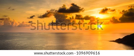 dramatic sunset at sea with cloudy sky landscap photo.