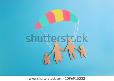 Social protection concept. family on the parachute