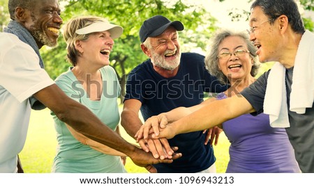 Active senior friends exercising at the park Royalty-Free Stock Photo #1096943213