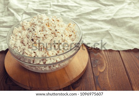 Salt popcorn on the wooden table