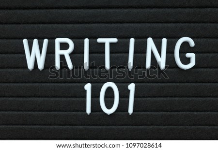 The words Writing 101 in white plastic letters on a black letter board as an introduction to writing skills for authors