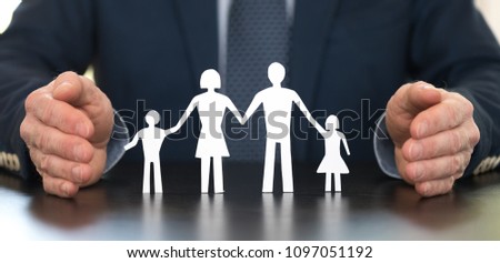 Insurer protecting a family with his hands