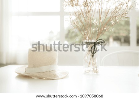Mock up : Stylish minimalistic white table workplace with hat and dry plant. copy space for product display montage.