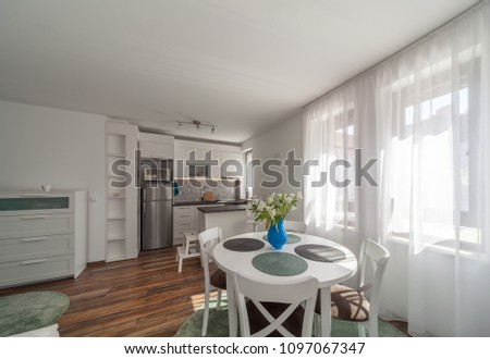 New modern living room with kitchen. New home. Interior photography. Wooden floor.