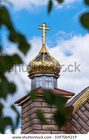 Golden domes and crosses of the orthodox church on a blue sky background.