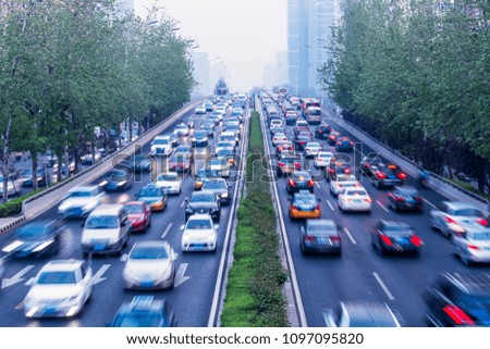 A blurred image of the daytime traffic movement