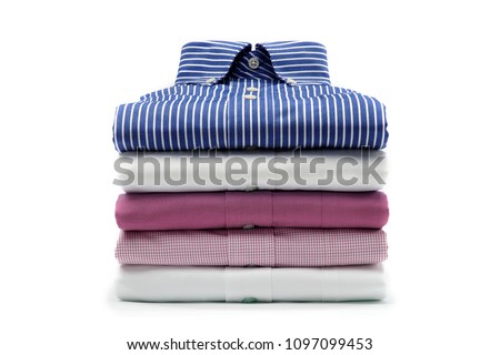 A varicolored plain, checkered and pinstriped folded mens dress shirts isolated over a white background