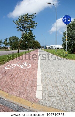 paved sidewalk with path for cyclists