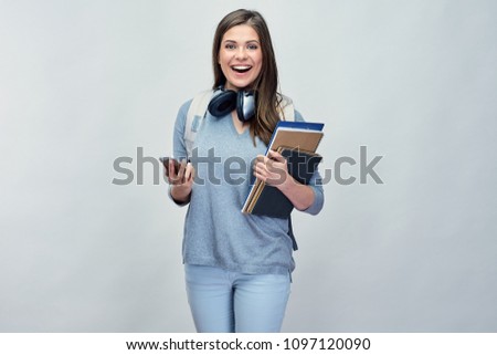 Student woman using smartphone. Isolated portrait on gray studio background.