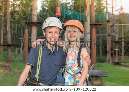 Brother and sister in adventure park.