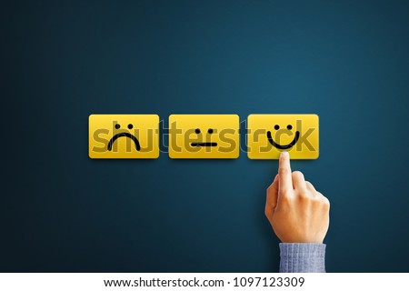Hand of client show a feedback with smiley face card. Service rating, satisfaction concept Royalty-Free Stock Photo #1097123309