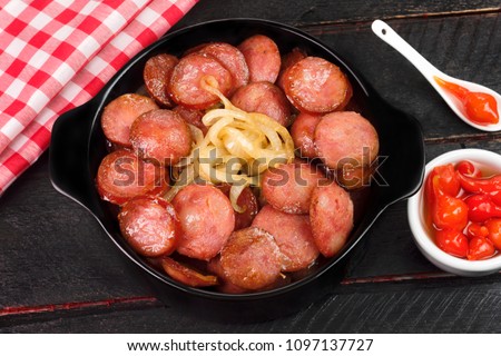 Sliced and fried Calabrese sausage seen from above