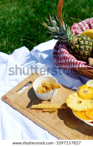 Picnic at the park on the grass: healthy food and accessories, top view