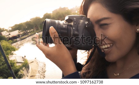 Outdoor summer smiling lifestyle portrait of pretty young woman having fun in the city of Lima taking pictures