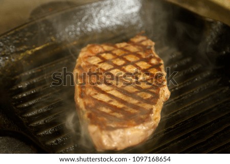 Ribeye steak in the frying pan