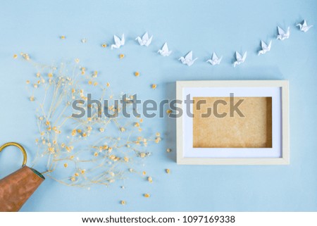 Top view of dried flower and twin white picture frame for your text  on pastel color background. Flat lay.
