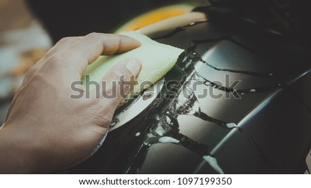 Car wash with hand and sponge background, Motorcycle background, Maintenance background.