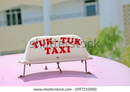 Tuk Tuk Taxi sign on the roof
