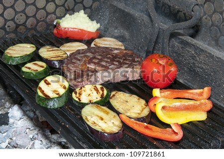 cooking steak and grilled vegetables