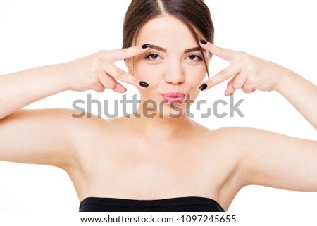 Gorgeous brunette woman posing and making kissy face. Closeup portrait of beautiful female person on white background, isolated, retouched, studio lighting