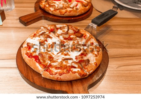 Fast food italian traditional.Hot chicken sausage pizza with cheese, imitation crab stick on wooden board table classic in top view.Closed up.Copy space.