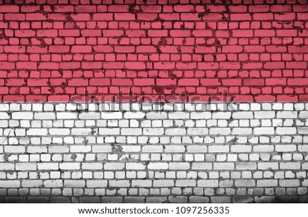 Indonesia flag is painted onto an old brick wall