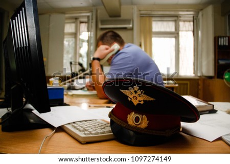 A policeman at work in the duty room
 Royalty-Free Stock Photo #1097274149