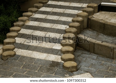 Sidewalk tiles in the form of an original pedestrian staircase made of tiles