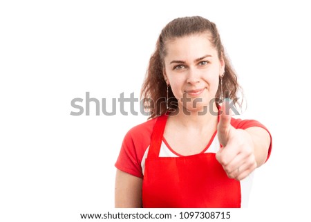 Young female supermarket employee showing thumbs up like gesture as happy retail worker concept isolated on white background