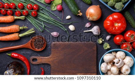 Picture on top of fresh vegetables, champignons, cutting board, butter