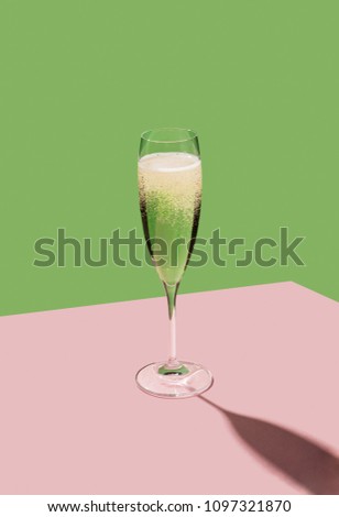 A flute filled with Prosecco, an italian white sparkling wine cultivated in Valdobbiadene. Pop colorful background Royalty-Free Stock Photo #1097321870