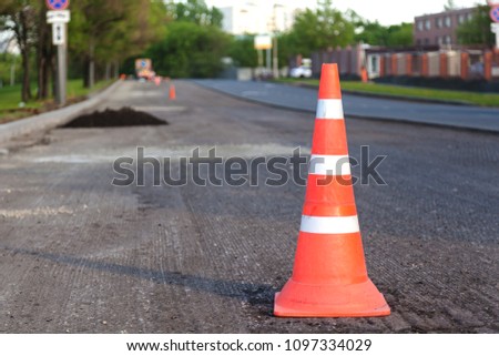 Orange cone on the road, the concept of "Road repair"