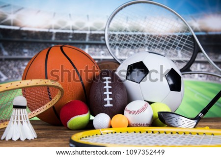 Sport equipment and balls, stadium background Royalty-Free Stock Photo #1097352449