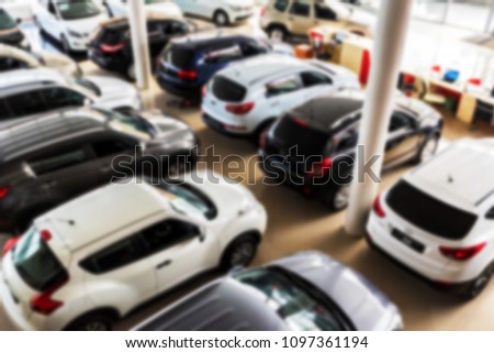 New cars at a car dealership blurred