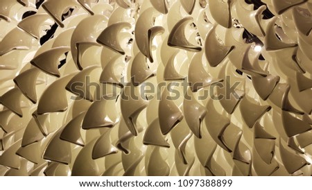 Abstract three-dimensional spiral texture in sepia shades. Wavy structure background. 3d curves surface of glass swirls closeup. Curly pattern backdrop. Glossy glass shapes. Closeup of glass lampshade