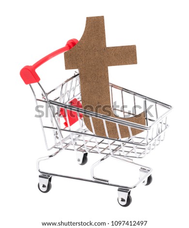 the lowercase wooden three-dimensional volumetric letter "t" in a mini shopping trolley cart on white background