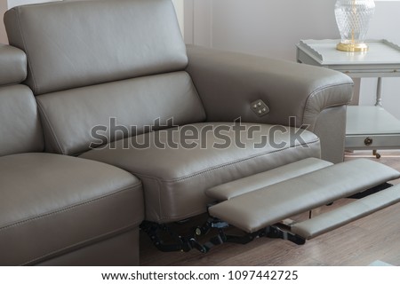 Modern Grey Leather Sofa, with recliner seat in open position. Royalty-Free Stock Photo #1097442725