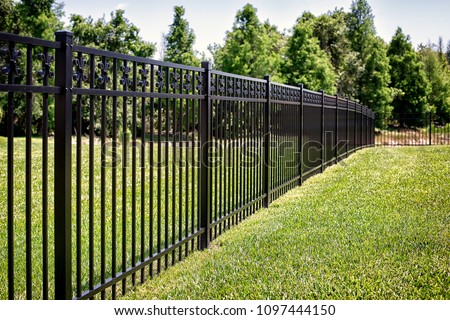 Black Aluminum Fence With Decorative Elements  Royalty-Free Stock Photo #1097444150
